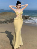 KYLETHOMASW  - Women Summer Sexy Club Set Yellow Backless Hollow Out Ruffles Short Tops And High Waist Elegant Wrapped Hip Long Skirt 2024 Suit