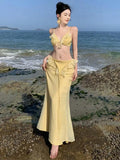 KYLETHOMASW  - Women Summer Sexy Club Set Yellow Backless Hollow Out Ruffles Short Tops And High Waist Elegant Wrapped Hip Long Skirt 2024 Suit